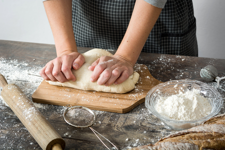 http://previews.123rf.com/images/chandlervid85/chandlervid851606/chandlervid85160600500/59875262-Woman-making-bread-on-wood-Stock-Photo.jpg